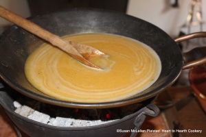 After the mixture of eggs, sack and sugar in a basin has been placed on the chafing-dish of coals for the receipt (recipe) To make a Sack Posset stir it one way until it be scalding hot.  Have in readiness three Quarts of Milk boiling hot, and pour it gently into the Bason to the Sack and Egg, and stir it about till it be all in.  The picture show one quart of milk added as I am preparing one third of the receipt.