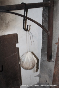 After the receipt (recipe) A Boiled Plumb-Pudding has boiled for five hours, the pudding bag needs to be removed from the kettle and allowed to drain and set.  I have been very successful with allowing a boiled pudding hang and set for an hour before opening the bag.